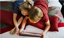 Kids Enjoying On Bed