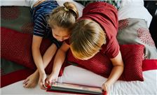 Kids Enjoying On Bed